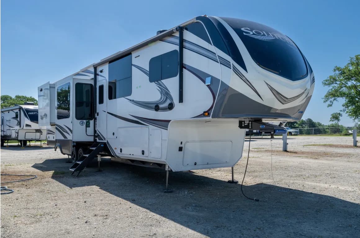 Triple W fifth wheel parked at a campsite