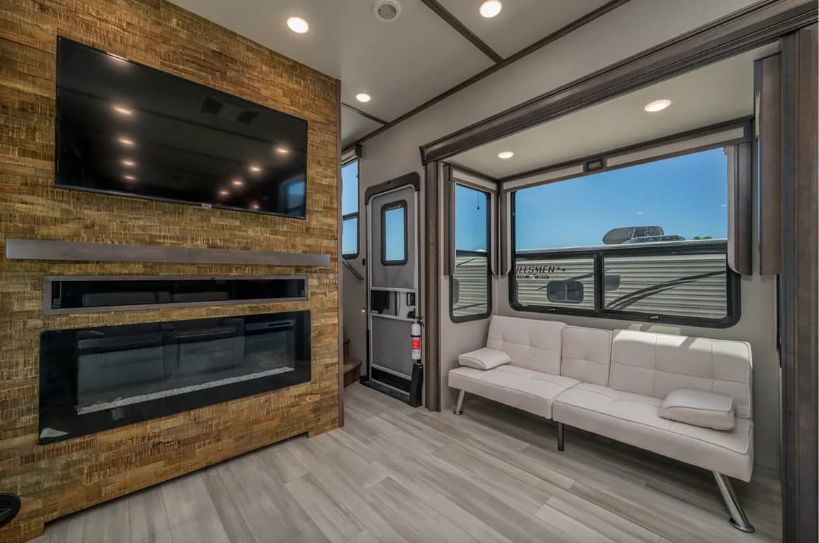 RV lounge with a fireplace, TV and sofa