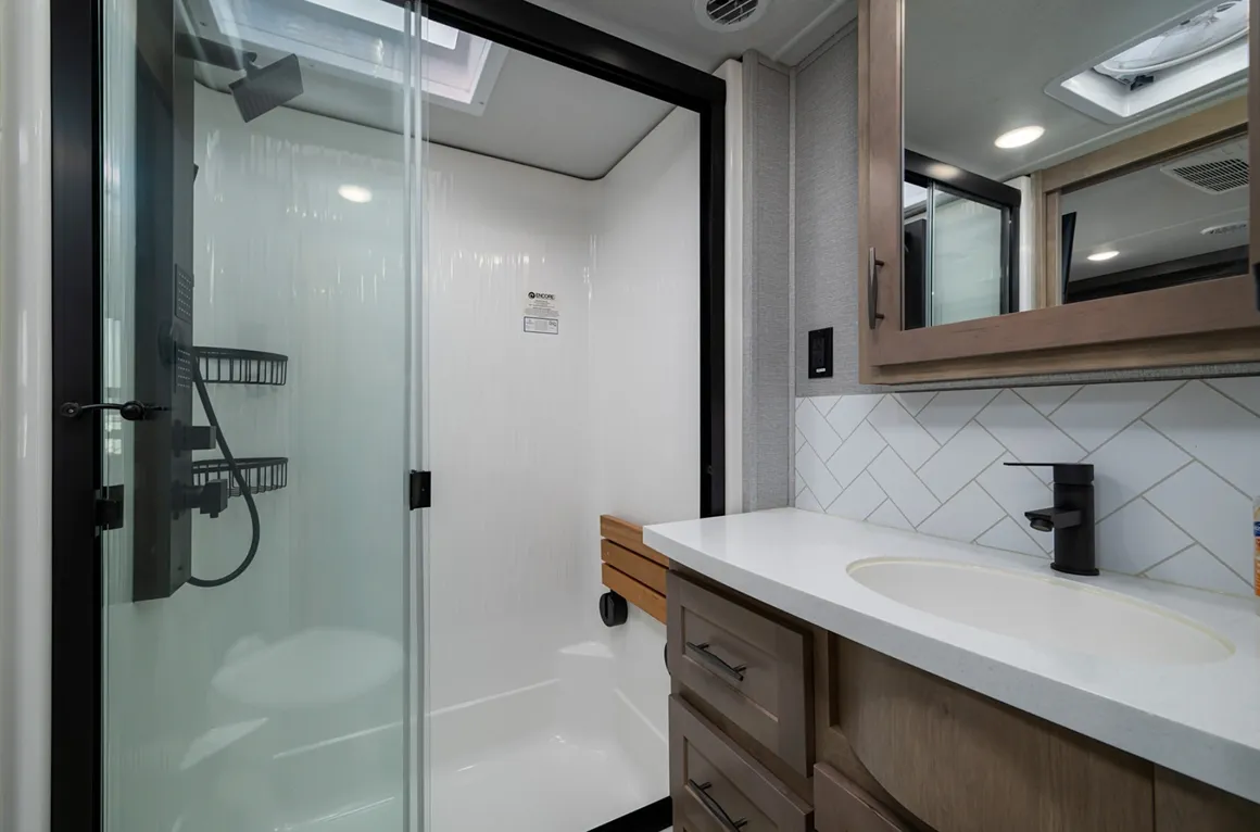 RV bathroom with a walk-in shower and vanity